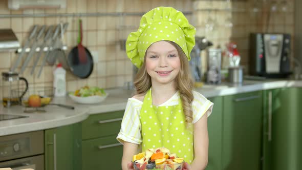 Smiling Child Holding Salad Bowl