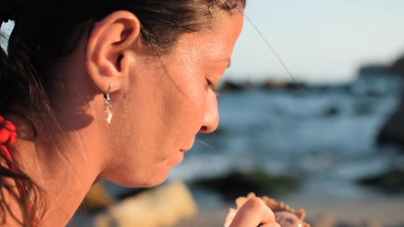 Closeup slowmo shot of a beautiful woman with a natural look eating with spoon delicious ice cream o