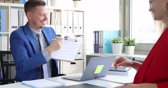 Smiling Businessman Shows Women How to Write Resume Correctly  Movie