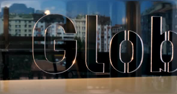 Glass Global Letters and Office in Background