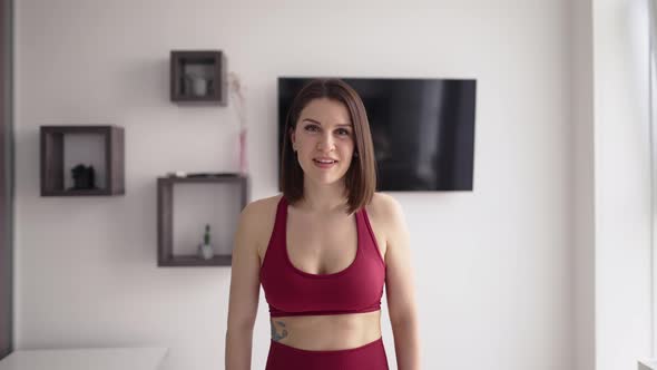 Woman Fitness Instructor Records a Tutorial on Home Workouts on Camera