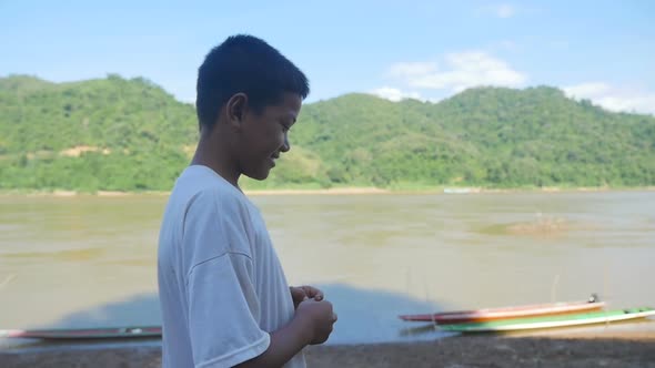 Boy Walking Near The River