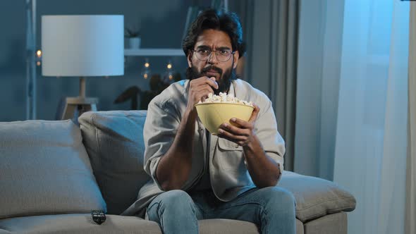 Serious Interested Arabic Hispanic Indian Bearded Man Guy Wearing Glasses 30s Male with Popcorn