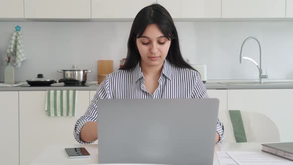 Young Indian Latin Mixed Race Girl Sitting at Desk with Pc at Kitchen Table