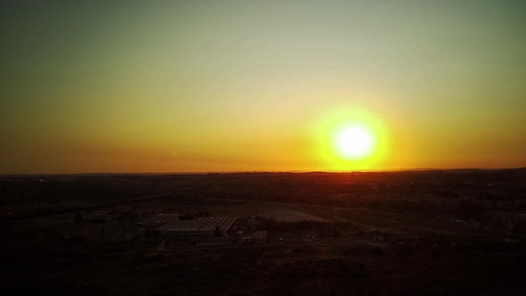 Flying Above the Industrial Area at Sunset Aerial View