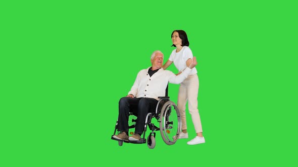 Young Woman Finally Taking Her Disabled Father in a Wheelchair Home on a Green Screen Chroma Key