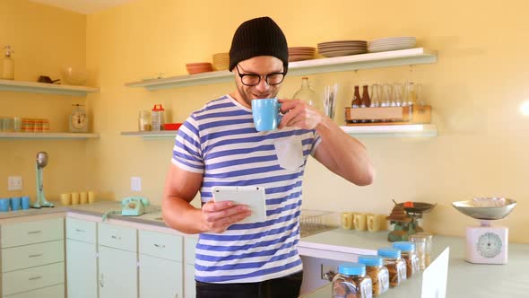 Man using digital tablet while having coffee 4k