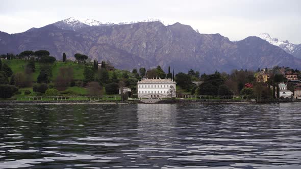 View From Lake Como to a White Villa on the Shore Surrounded By Forest