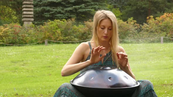 Hungpan in Hands of Woman Outdoors