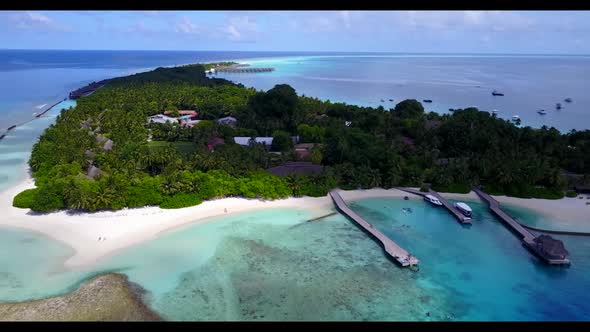 Aerial view panorama of tranquil seashore beach holiday by blue green sea with white sandy backgroun