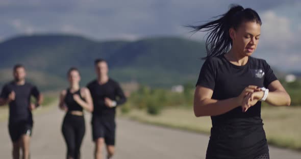 Multiethnic Group of Athletes Running Together on a Panoramic Road