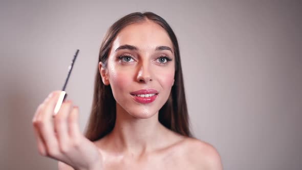 Girl Applying Eyeliner on Her Eyes