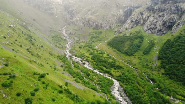 Mountain River Flowing Down From Rocks Through Green Gorge. Mountain Spring Flowing Down Gorge with