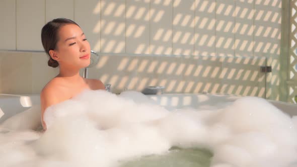 Young asian woman relax in bathtub