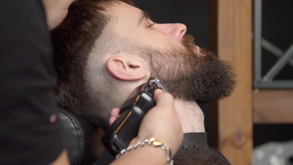 Barber Trimming Beard of Client