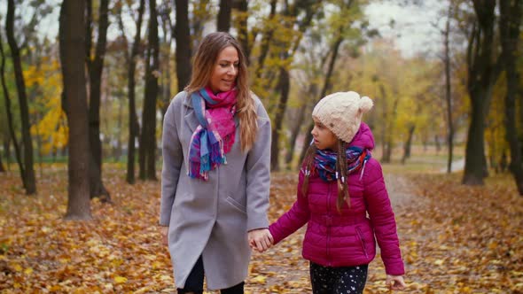 Joyful Mother and Daughter Enjoying Leisure in Autumn