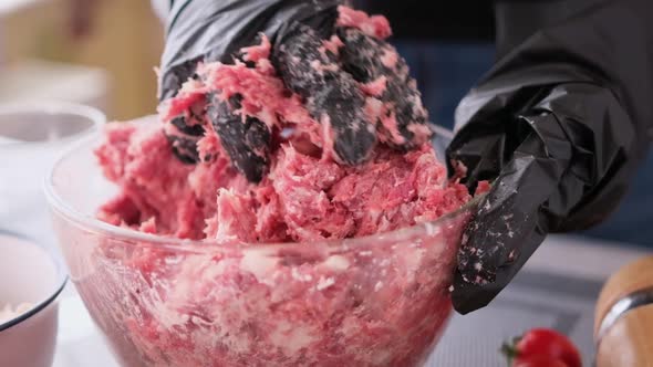 Kneading of Minced Meat with Onion and Spices in a Glass Bowl