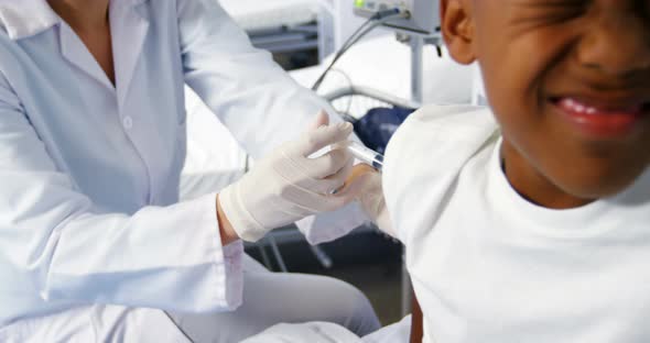 Doctor giving an injection to a boy