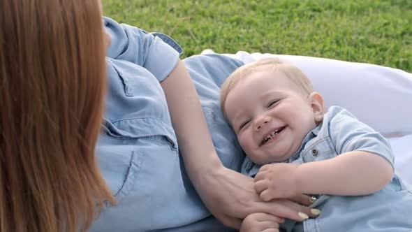 Mother Tickling Cute Baby