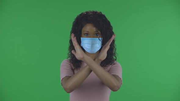 Portrait of Beautiful African American Young Woman in Medical Protective Face Mask Looking at Camera