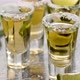Golden Tequila Shots Served with Lime and Sea Salt on Table - VideoHive Item for Sale