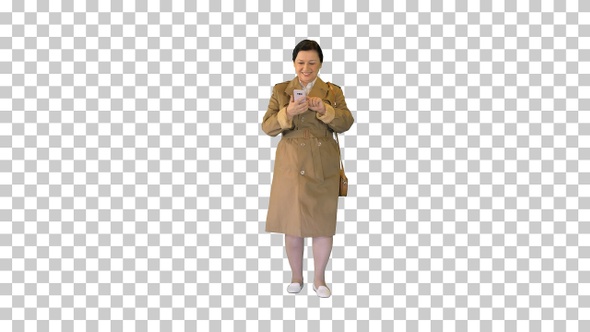 Middle aged woman in trench coat walking, Alpha Channel