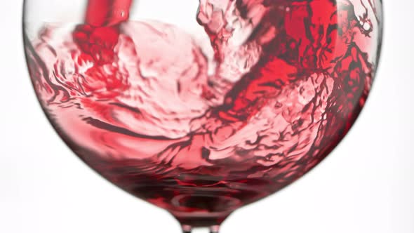 Super Slow Motion Detail Shot of Pouring Red Wine Isolated on White Background at 1000Fps