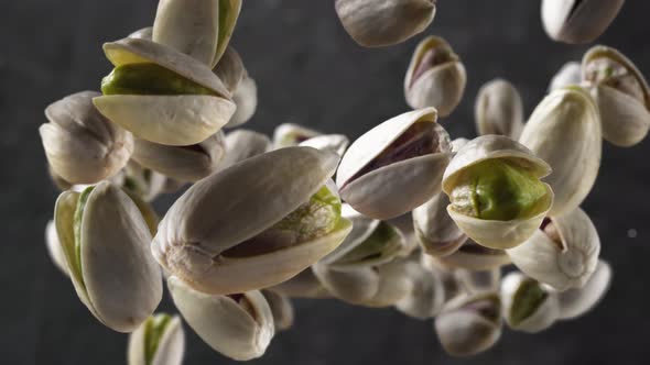 Flying of Pistachios in Dark Kitchen Background