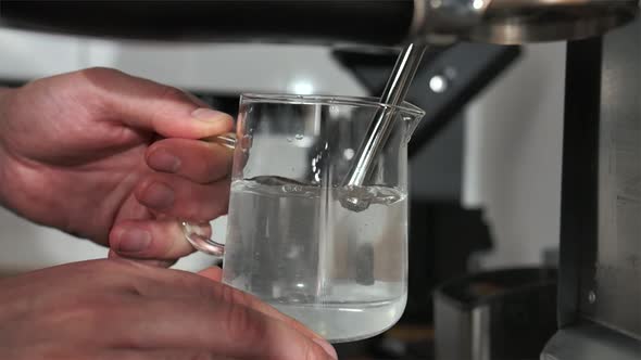 Hot Water Under the Pressure of Air is Poured Into a Cup