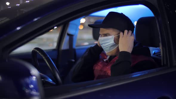 Delivery Man Putting on Medical Face Mask to