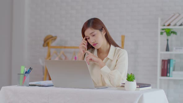 Business Asian young woman working with computer laptop and thinking to get ideas