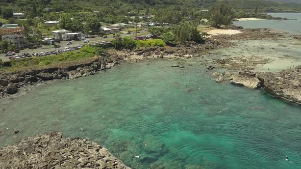 Aerial view of swimmers enjoying the clear water at Sharks cove 5
