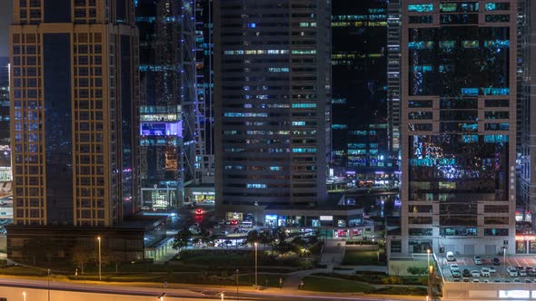 Aerial View of Jumeirah Lakes Towers Skyscrapers Night Timelapse with Traffic on Sheikh Zayed Road