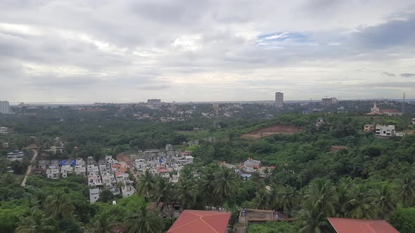 Static shot of vegetation and buildings in Mangalore district, India.