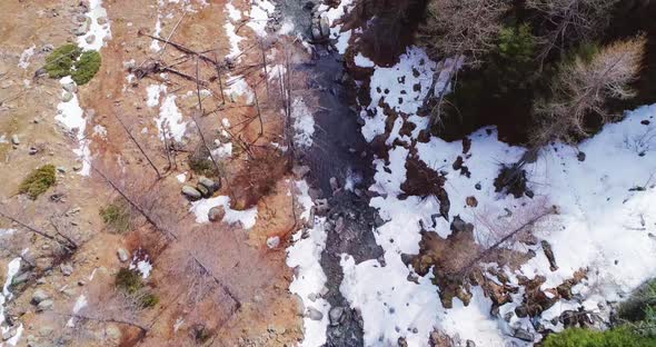 Aerial Flight Overhead Over River Creek in Yellow Mountain and Forest Fall Establisher
