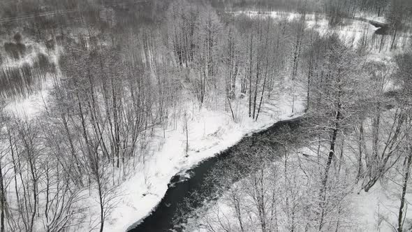 Christmas Snowy Fabulous Landscape with a Nonfreezing River Aerial View