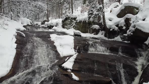 Winter waterfall in forest.