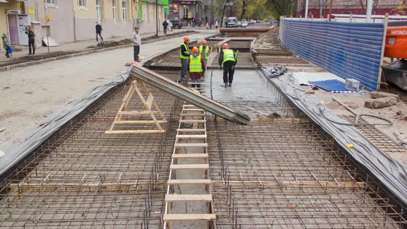 Concrete Works for Road Maintenance Construction Site with Many Workers and Mixer Timelapse