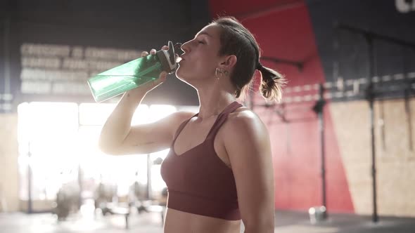 Woman drinking water during workout