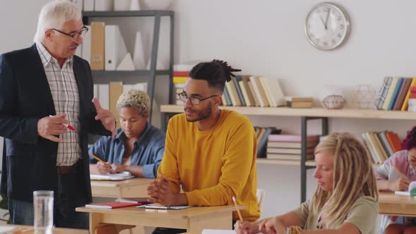 Mixed-Race Male Student Having Discussion with Professor