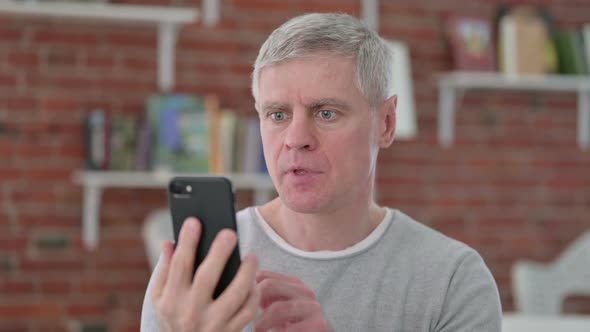 Sad Senior Old Man Getting Loss on Smartphone