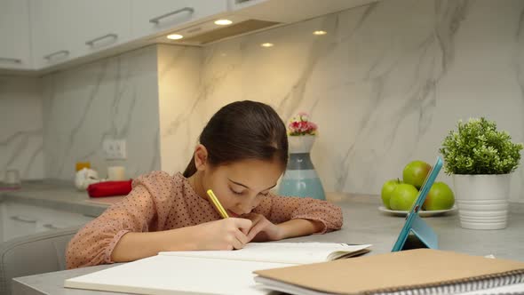 Schoolgirl with Bad Posture Studying Elearning App on Tablet Indoors