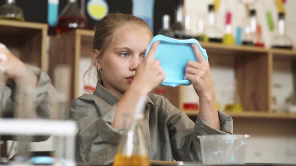 Laboratory Experience in a Chemistry Lesson,, a Girl Playing with a Blue Slime, Children's