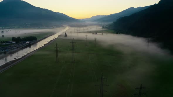 Drone Over Misty Landscape Of Zell Am See With Lake And Pylons