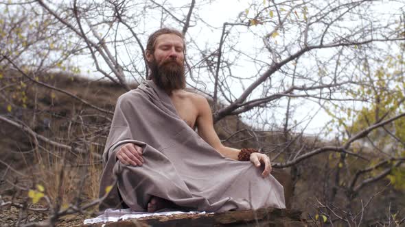 Ascetic Yogi Sitting in Meditation