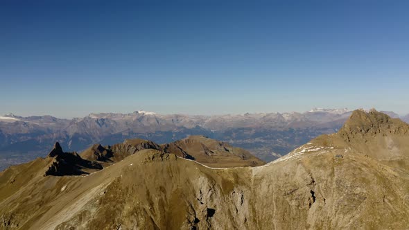 Aerial reveal of mountainous landscape and Rhône Valley in the backgroundVal d'Hérens and Vallon de