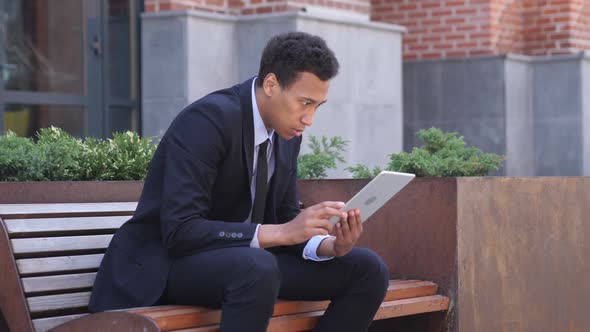 African Businessman Reacting to Failure While Using Tablet