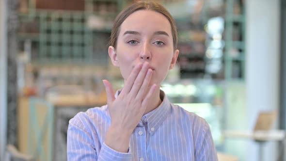 Portrait of Flying Kiss By Attractive Young Businesswoman