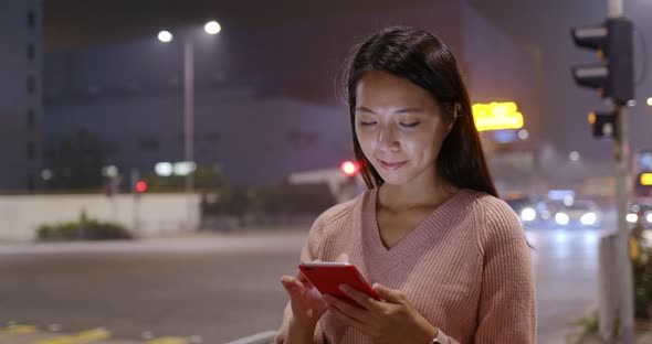 Woman use of mobile phone at night
