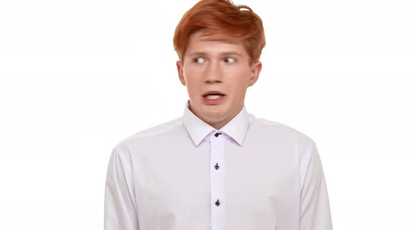 Young Redhead Caucasian Man Standing Scared on White Background